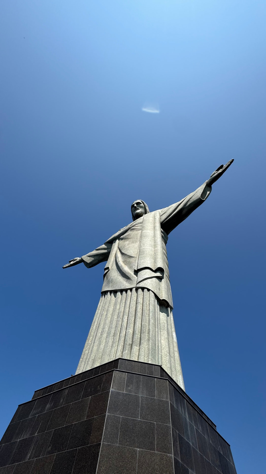 Dramatic low-angle portrait of Christ the Redeemer and its pedestal