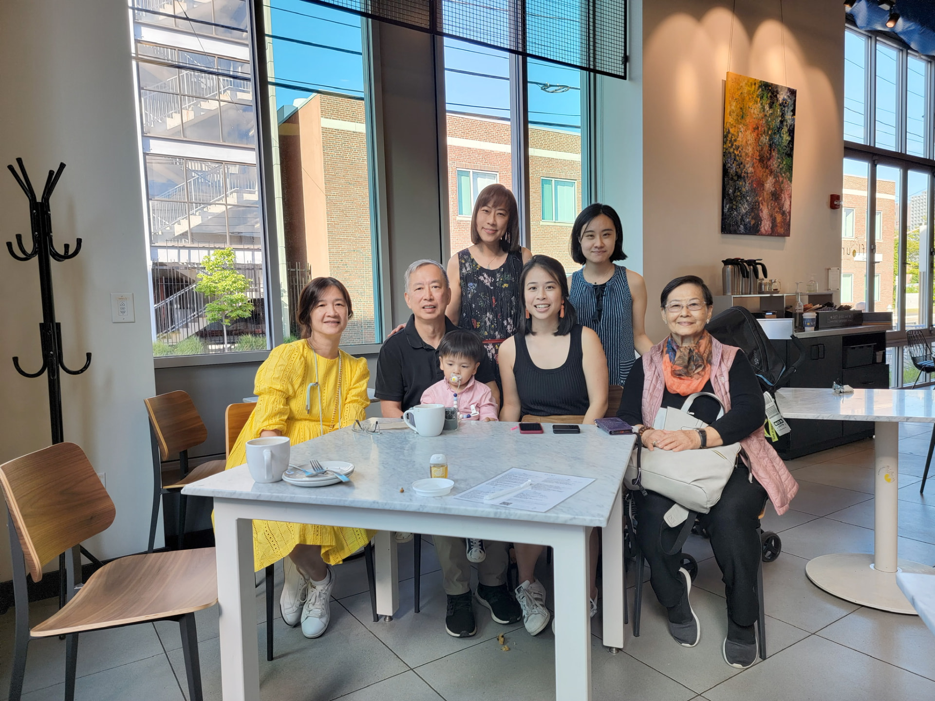 Family gathered around a café table in Boston
