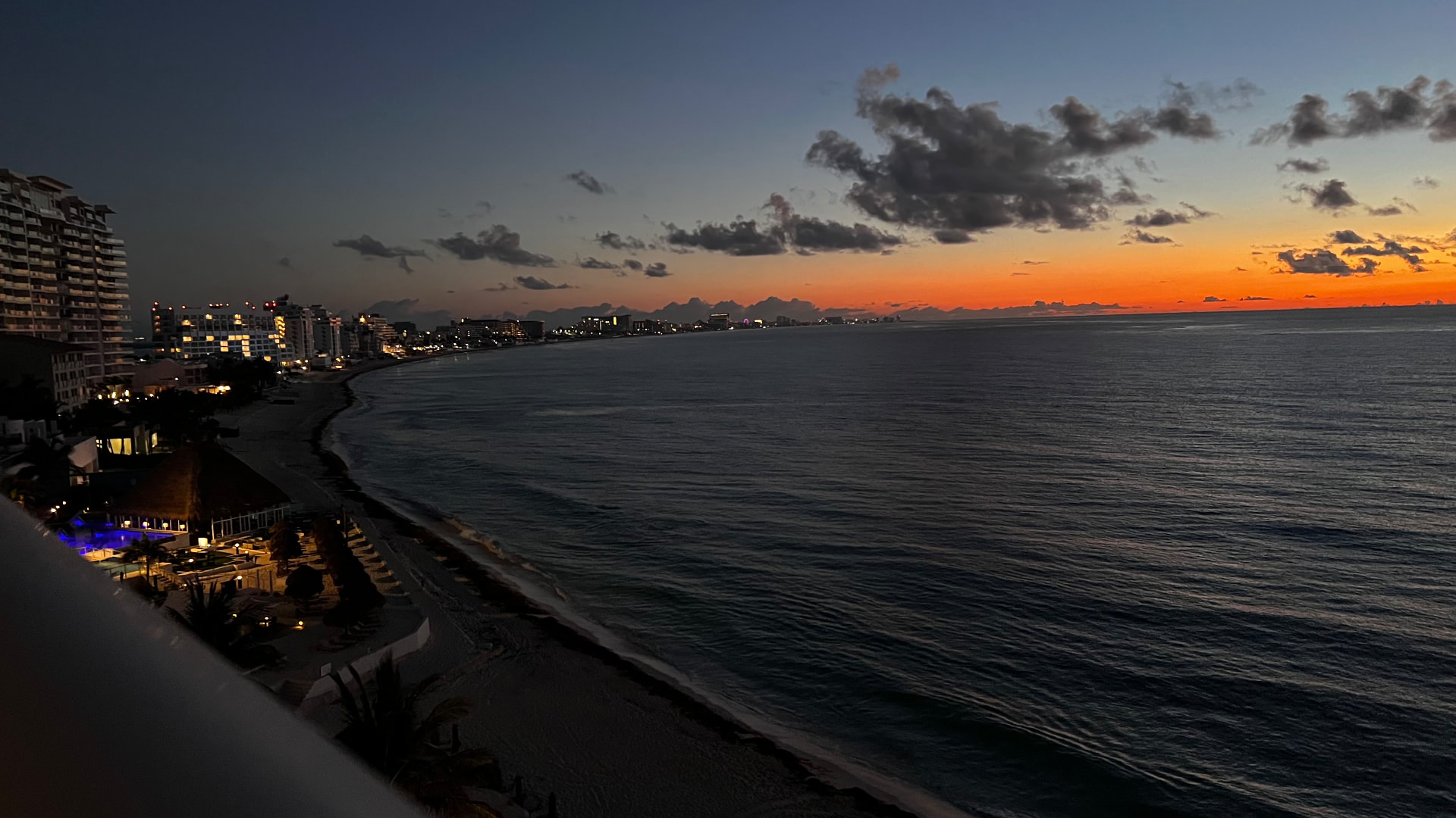 Cancún coastline glowing orange after sunset