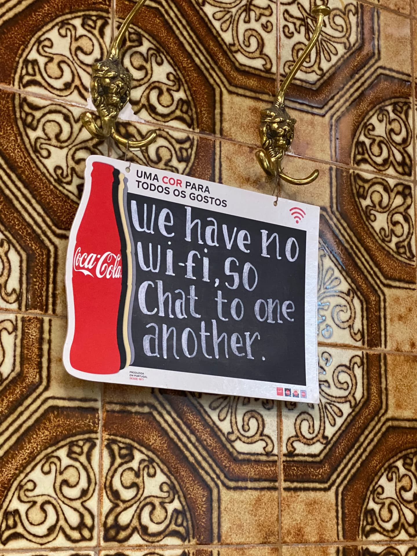 A restaurant sign reading: we have no Wi-Fi, so chat to another