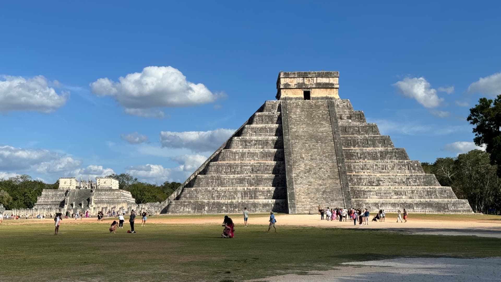 Frontal view of El Castillo with the Temple of the Warriors in the distance