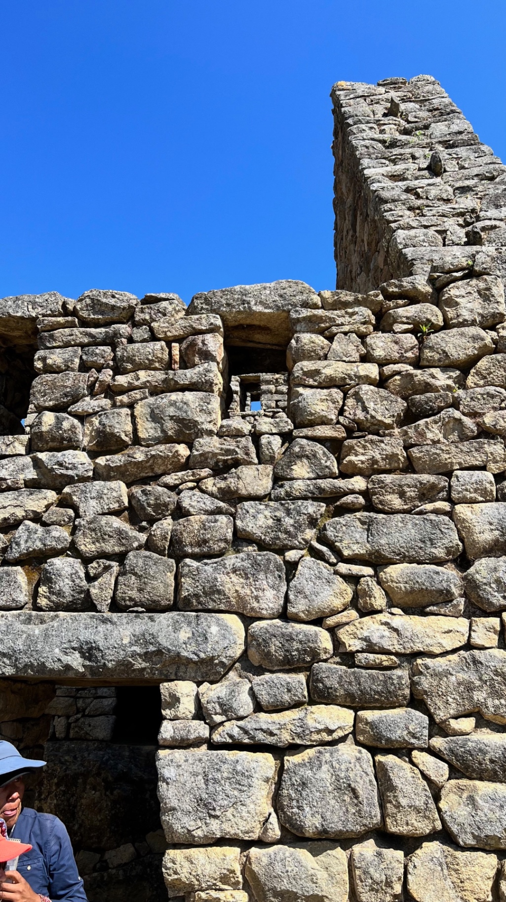 Rugged stone wall and tower viewed against an intensely blue sky