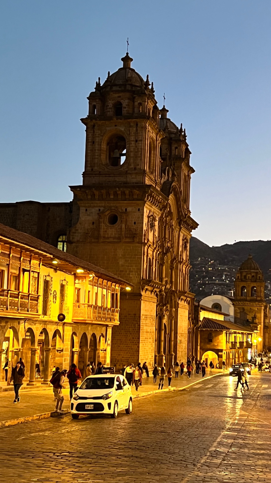 Cusco Cathedral and its bell tower glowing after sunset