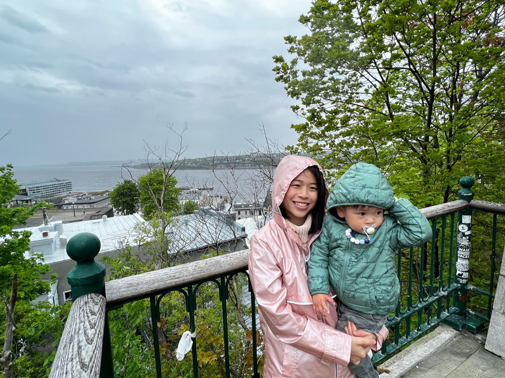 Mother holding her child at an overlook above the St. Lawrence River