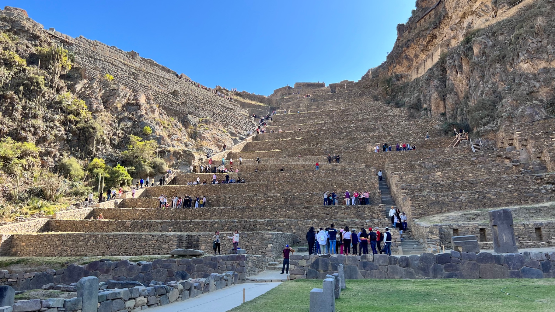 Visitors climbing the immense terraces of Ollantaytambo
