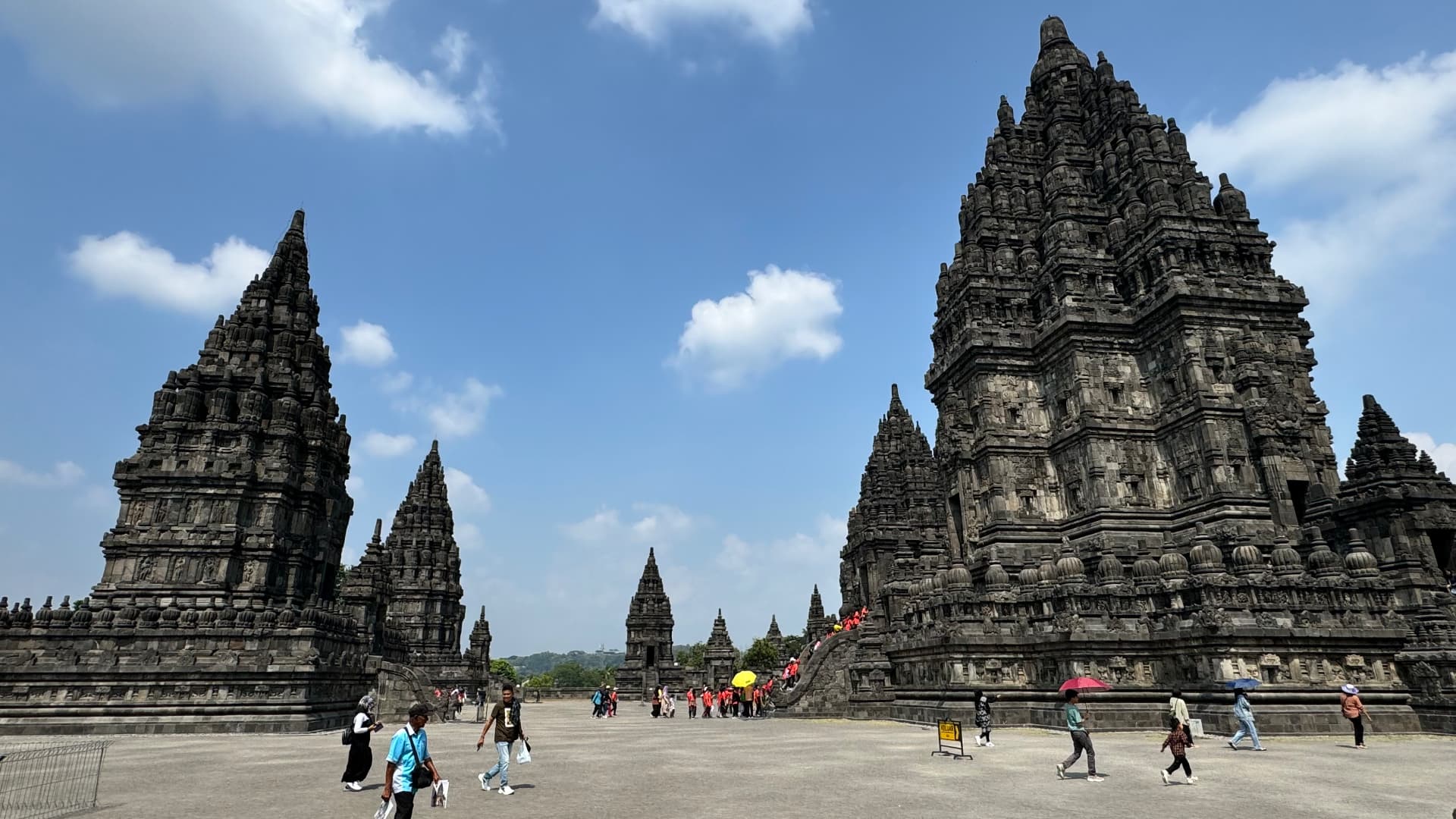 Prambanan towers beneath a blue sky