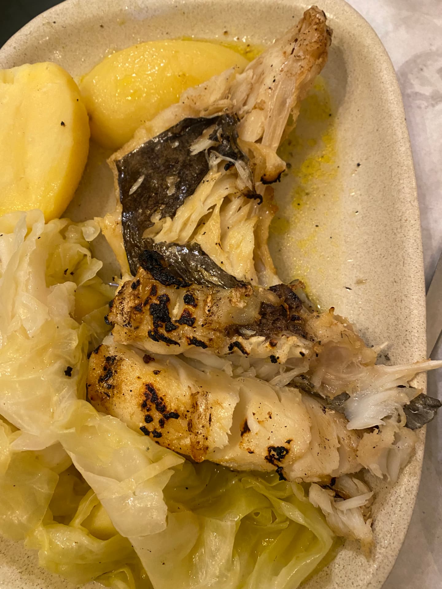 Grilled fish served with cabbage and potatoes