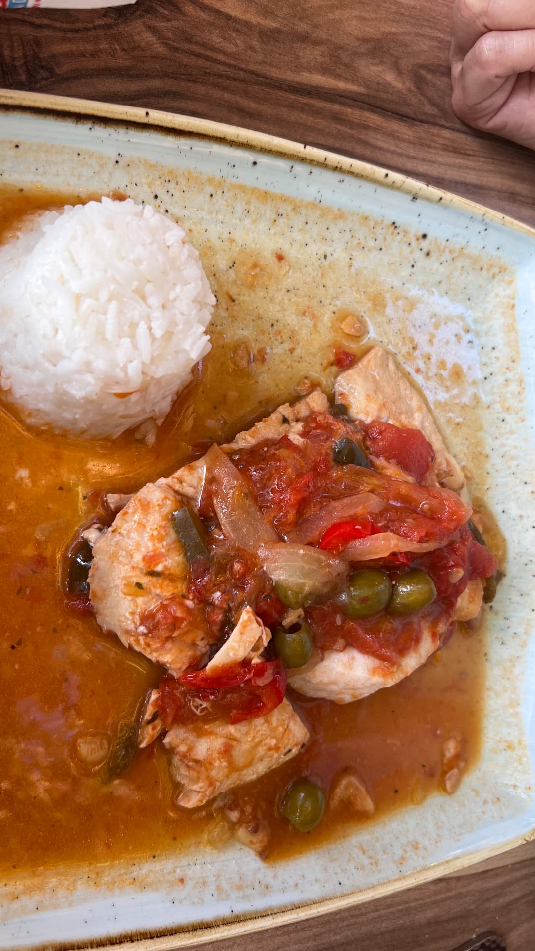 Fish in tomato sauce with olives, peppers, onions, and rice
