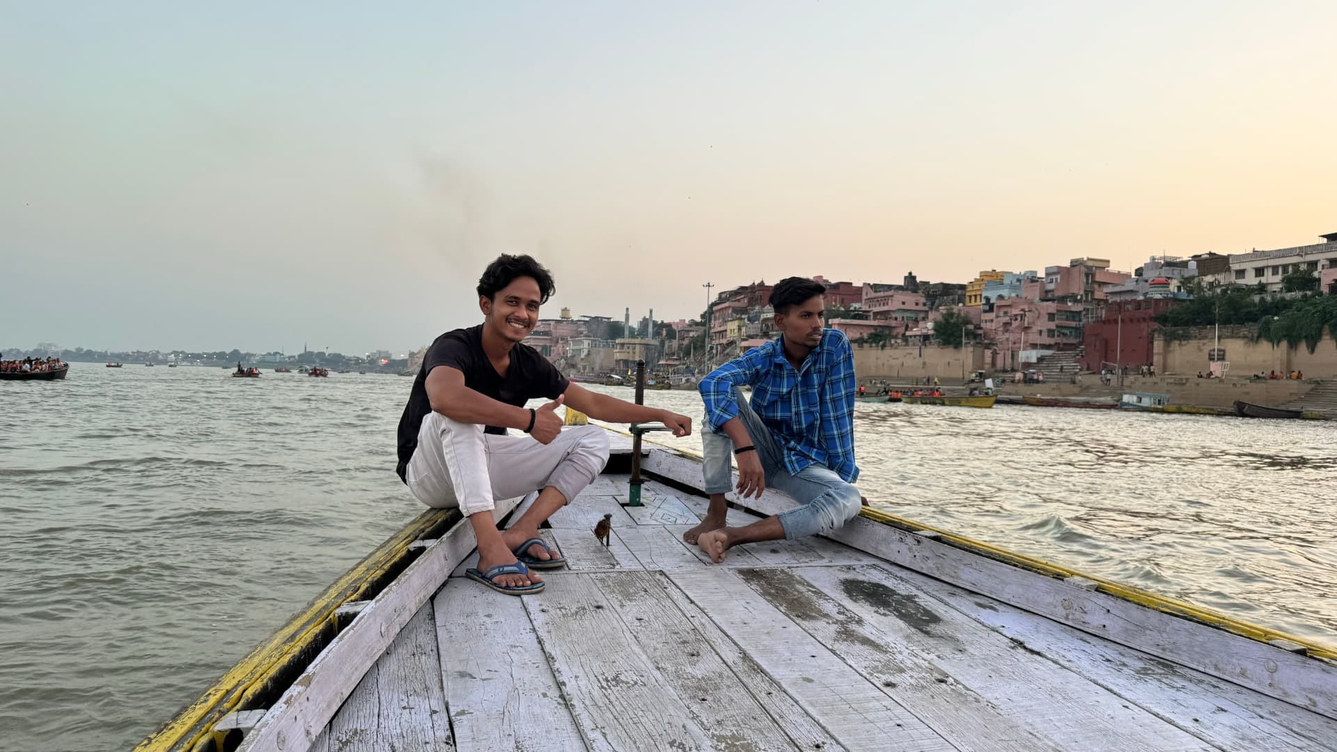 Looking forward along the boat as we travel beside the ghats. — Varanasi, Uttar Pradesh, India.