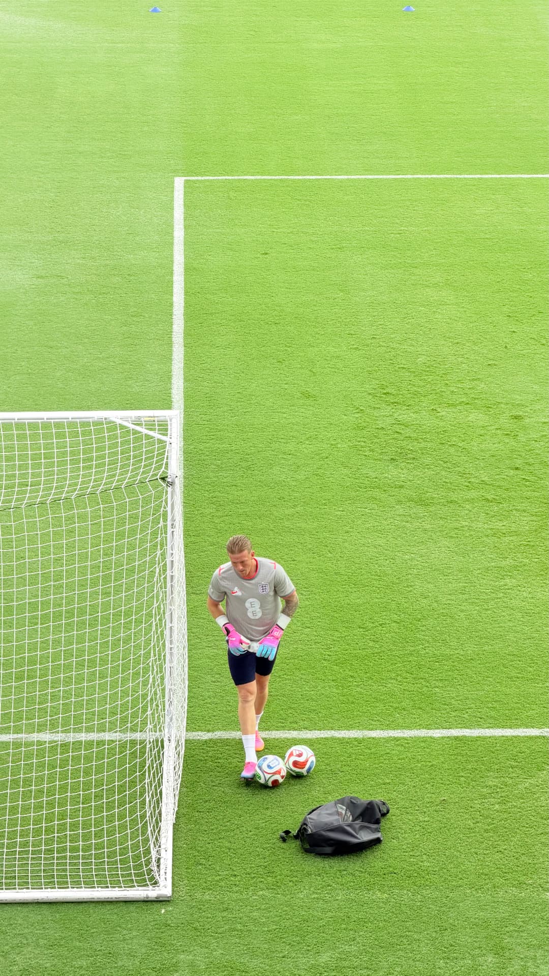 England goalkeeper preparing beside the goal with two footballs