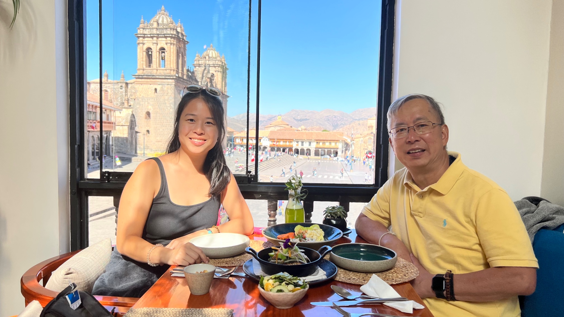 Ken and Jocelyn sharing breakfast beside a window overlooking Cusco