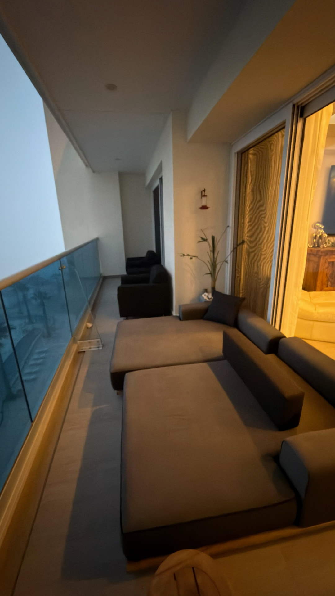Outdoor lounge seating along a long oceanfront balcony