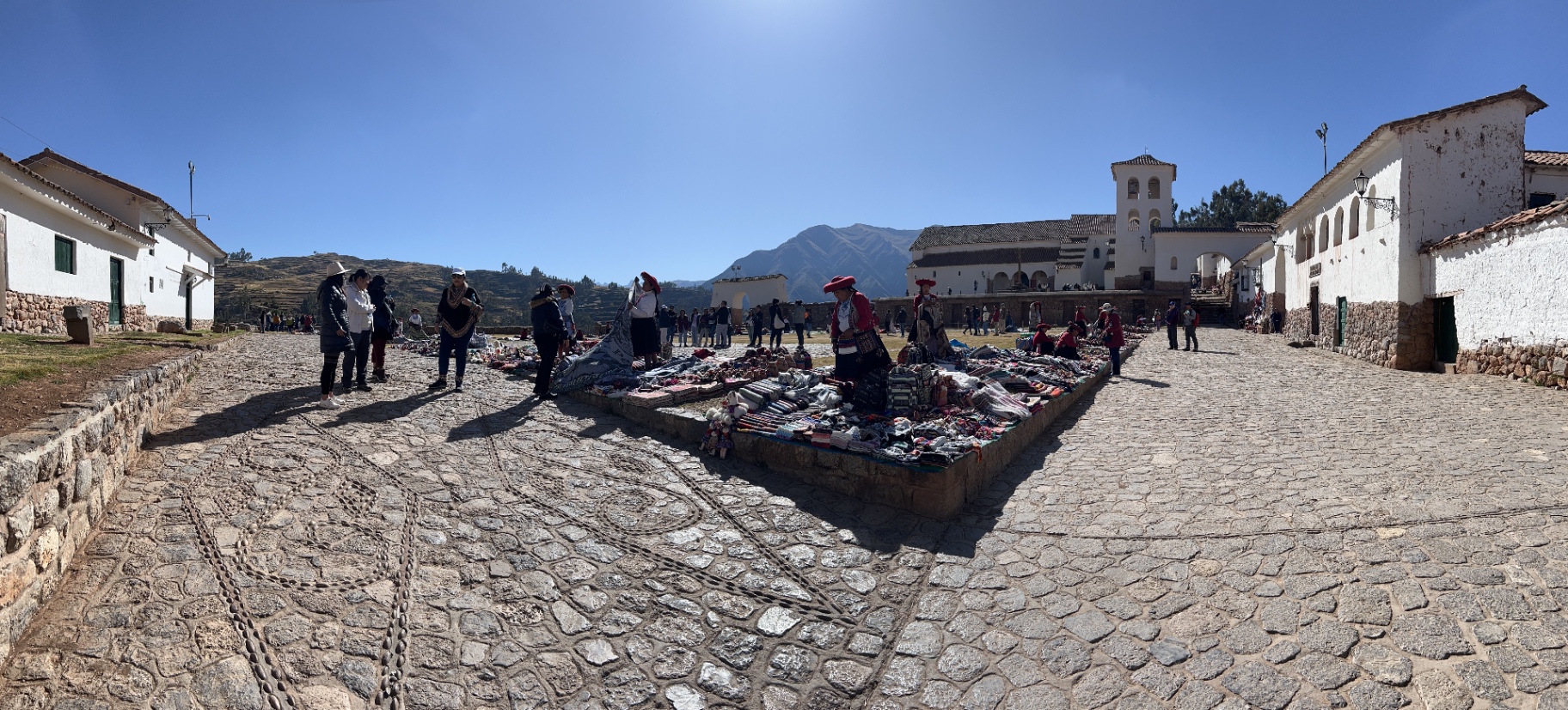 Visitors gathered beside a stone courtyard in the Sacred Valley