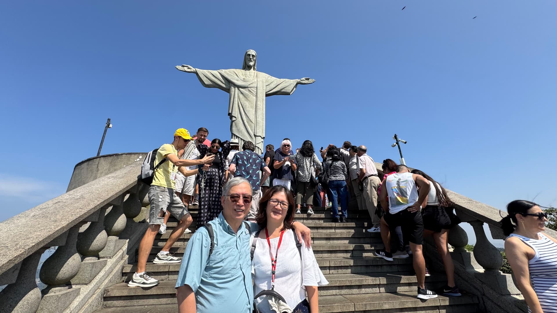 Ken and his companion standing on the steps below Christ the Redeemer