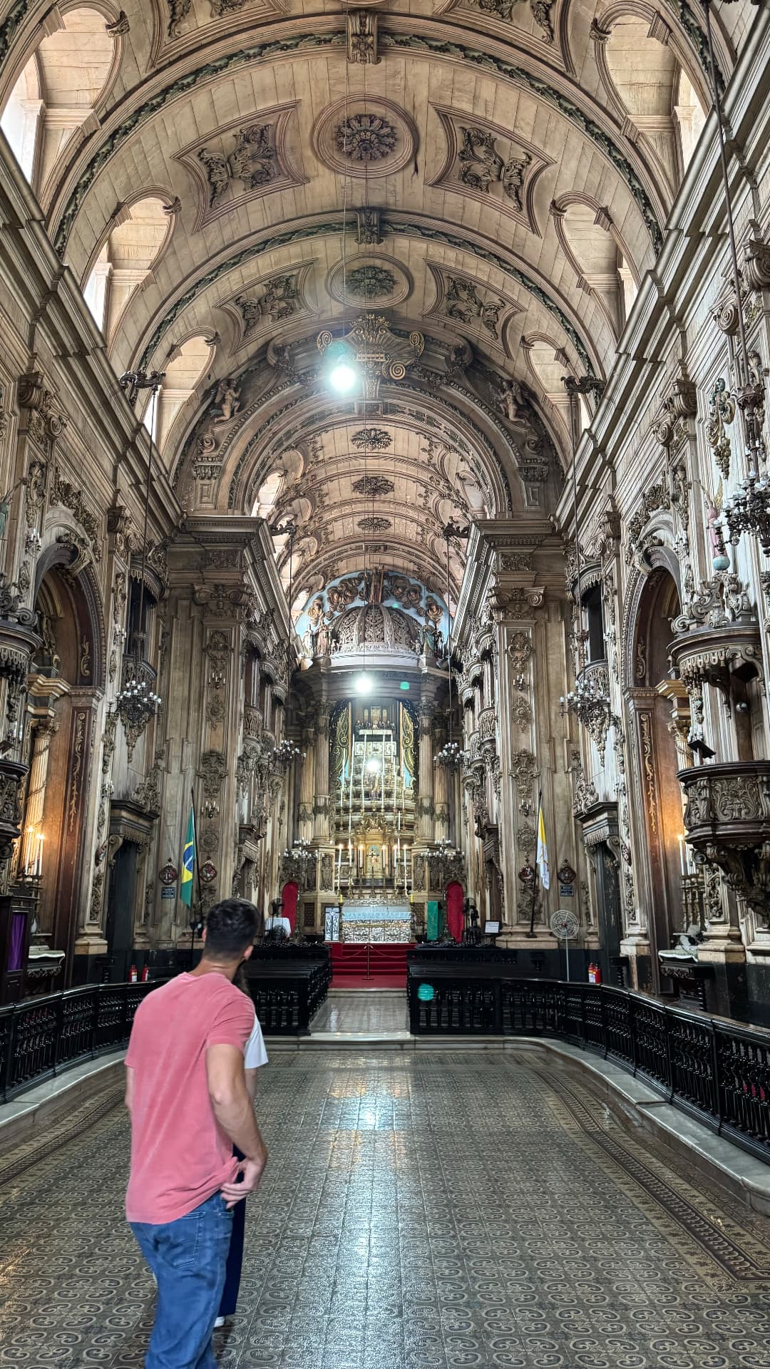 Highly decorated historic church interior with a vaulted ceiling and altar