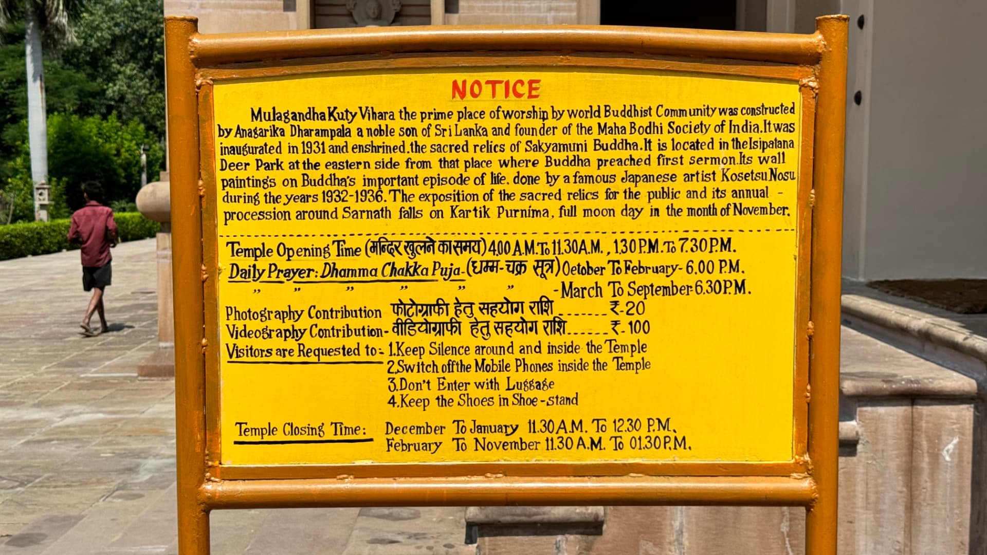 A teaching board shares Buddhist reflections with garden visitors. — Sarnath, Uttar Pradesh, India.