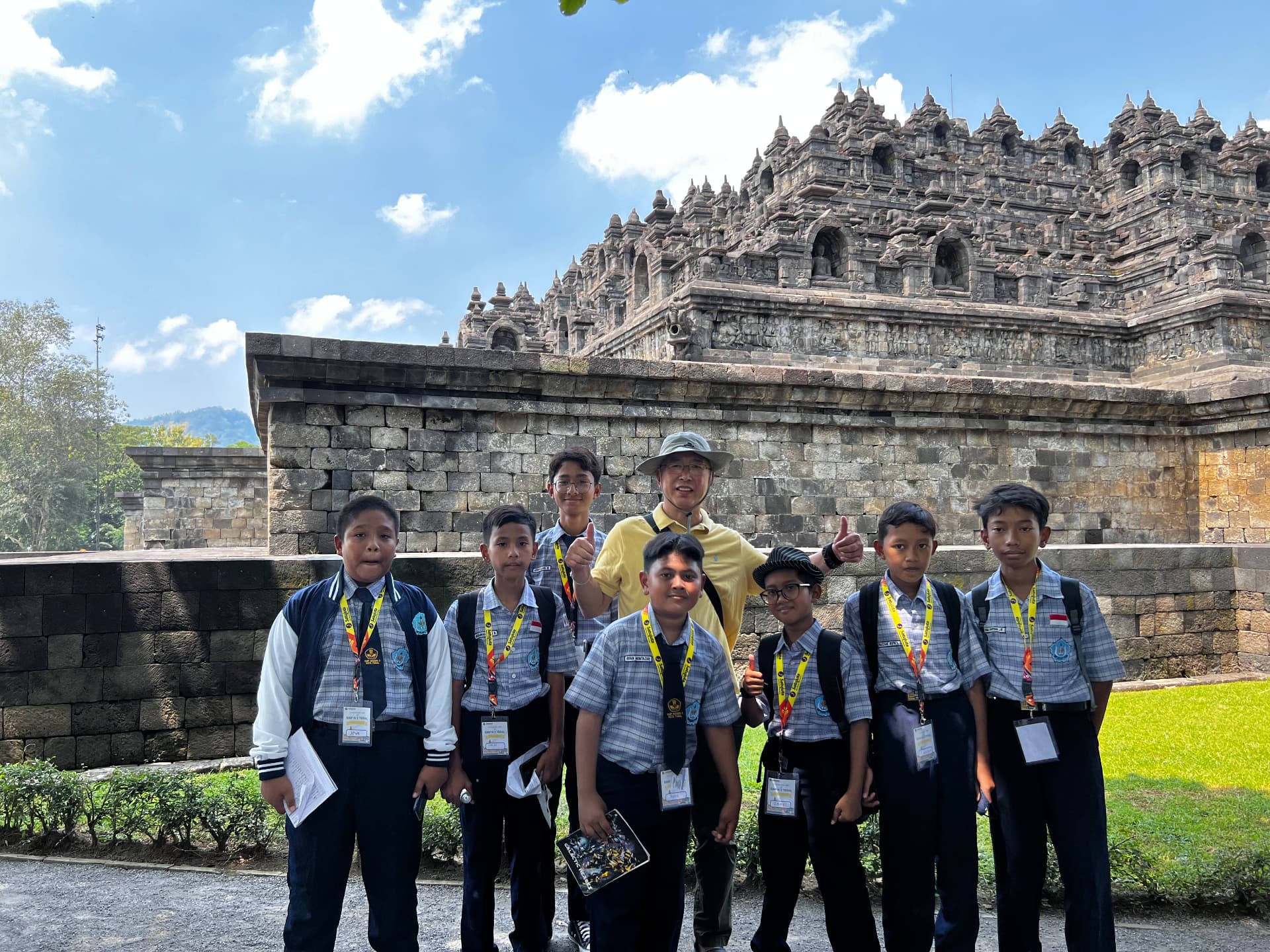 Ken posing with a group of local students beside the temple