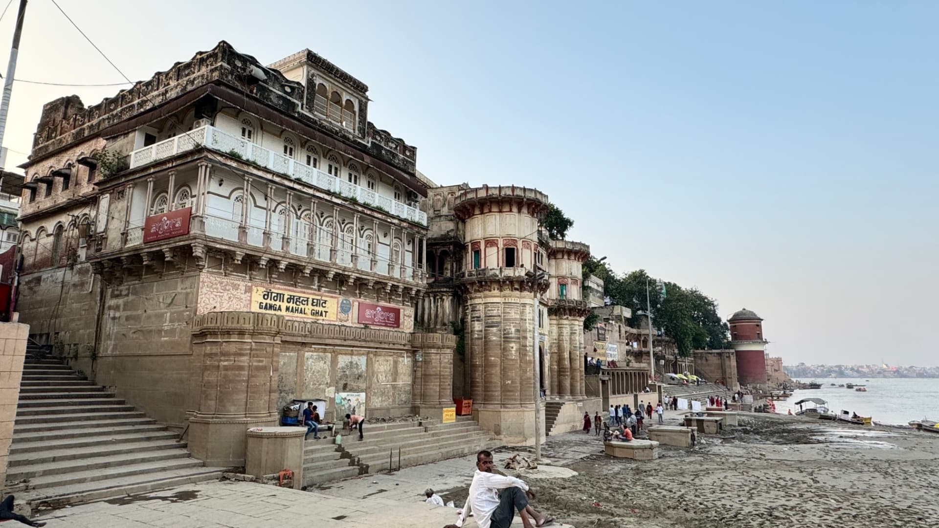 An imposing riverside building rises above the ghats. — Varanasi, Uttar Pradesh, India.