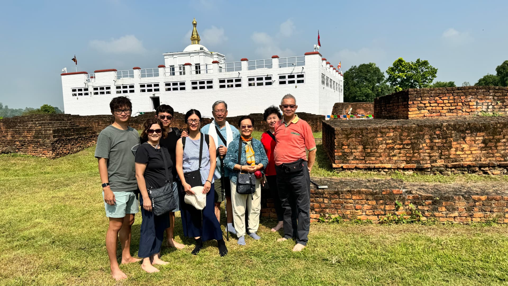 Our pilgrimage group pauses for a photograph beside the Maya Devi Temple. — Lumbini, Nepal.