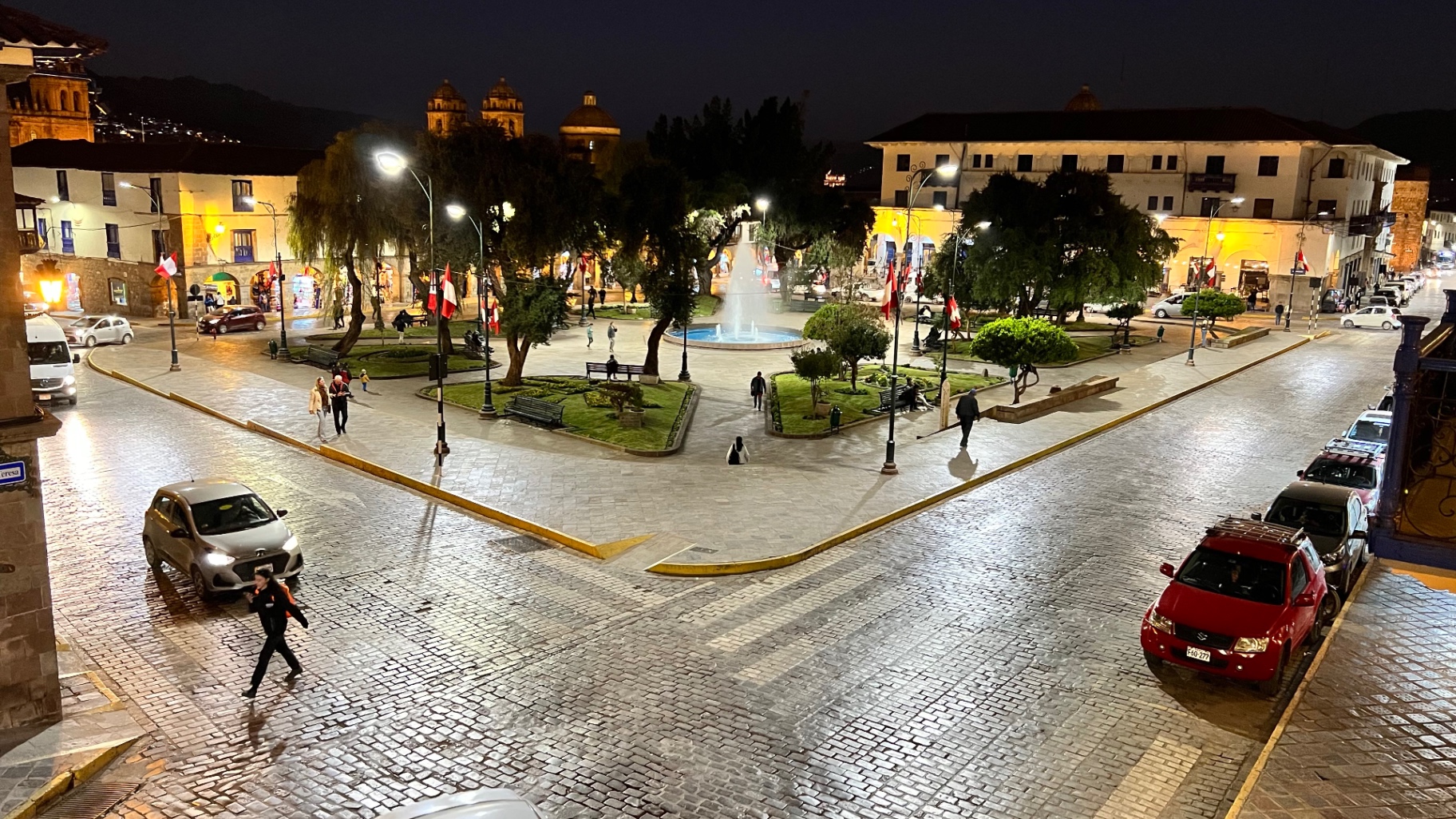 Night view over a lively street and plaza in central Cusco