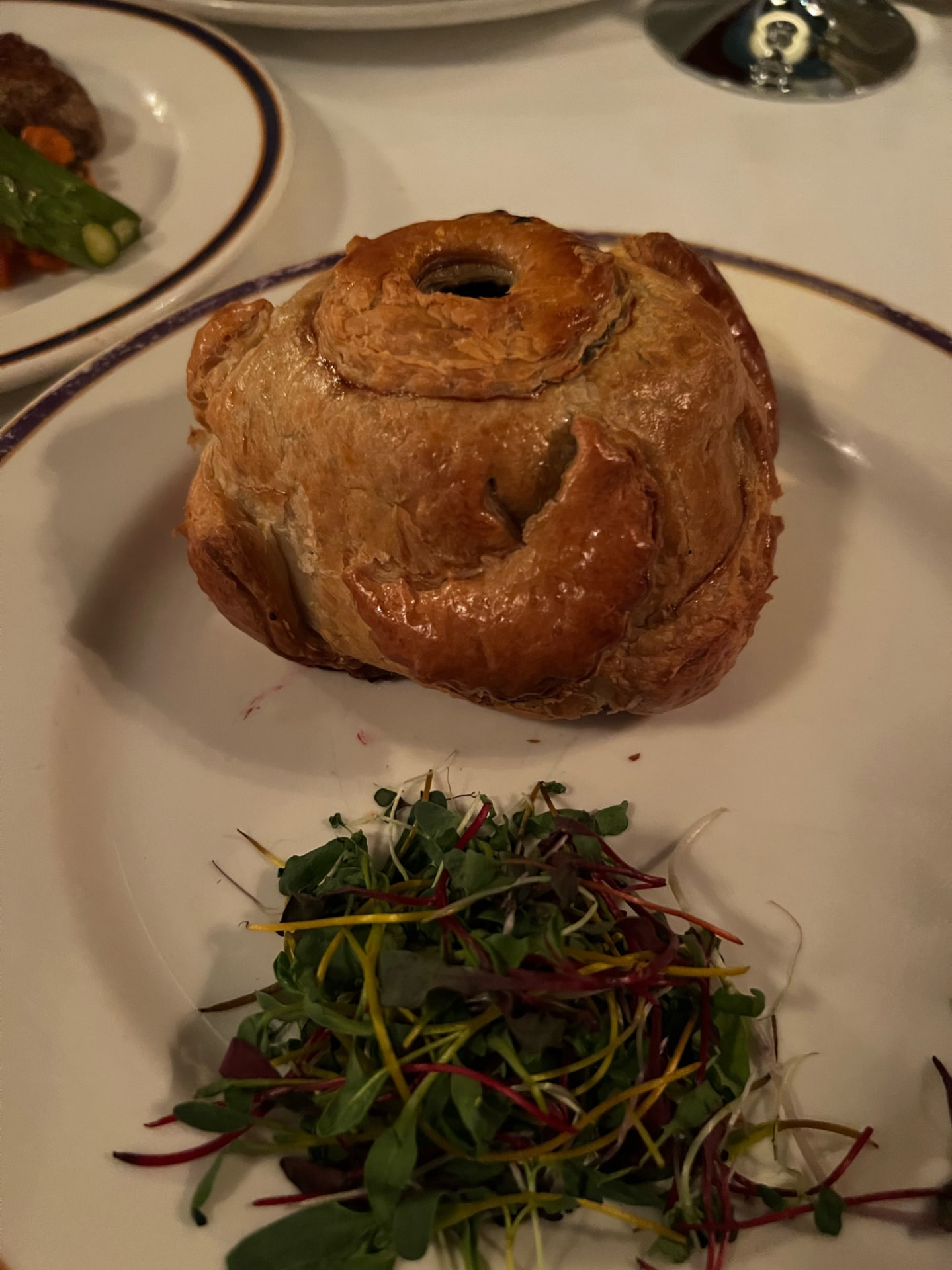 Pastry-wrapped entrée served with a small salad