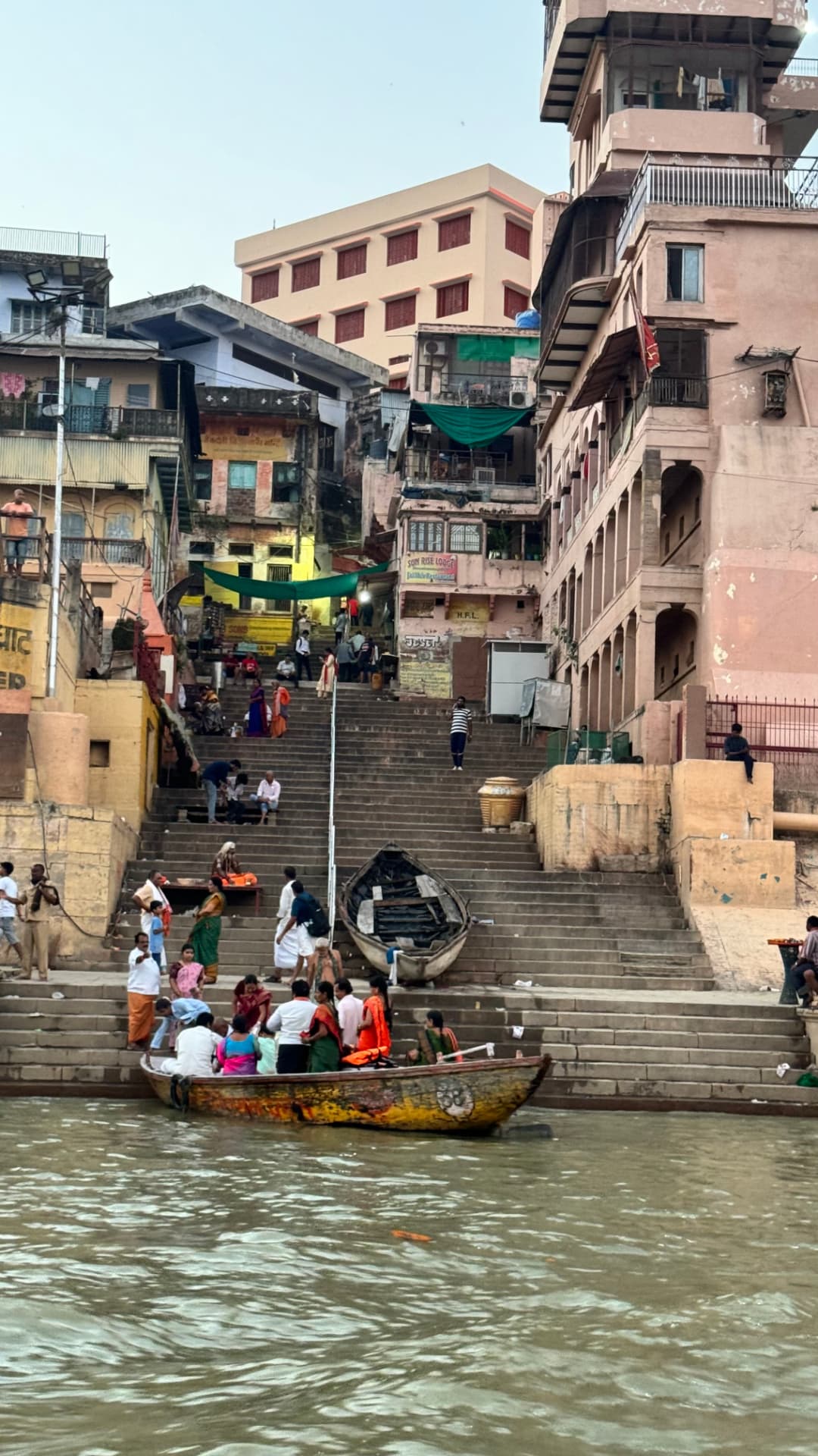 A narrow view up the ghat steps between tall buildings. — Varanasi, Uttar Pradesh, India.