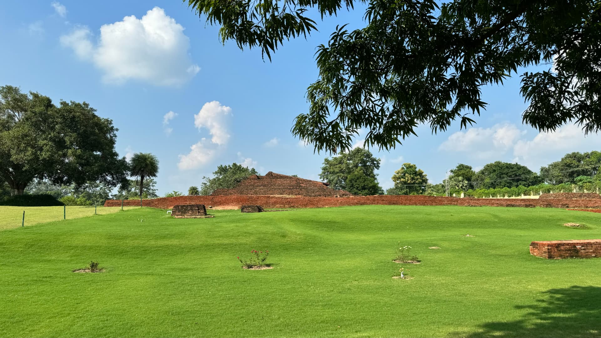 Green lawns surround the excavated brick remains of Nalanda Mahavihara. — Nalanda, Bihar, India · Patna chapter.