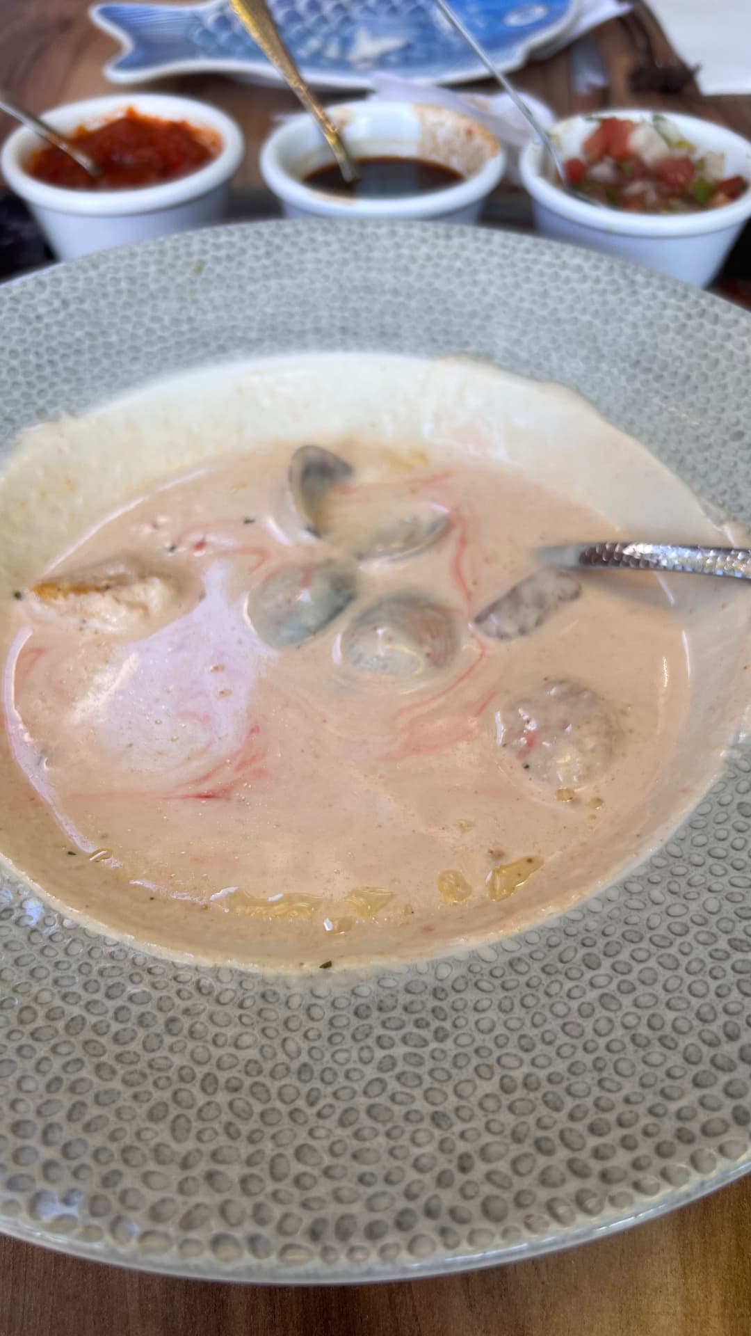 Creamy seafood chowder served with salsa and pico de gallo