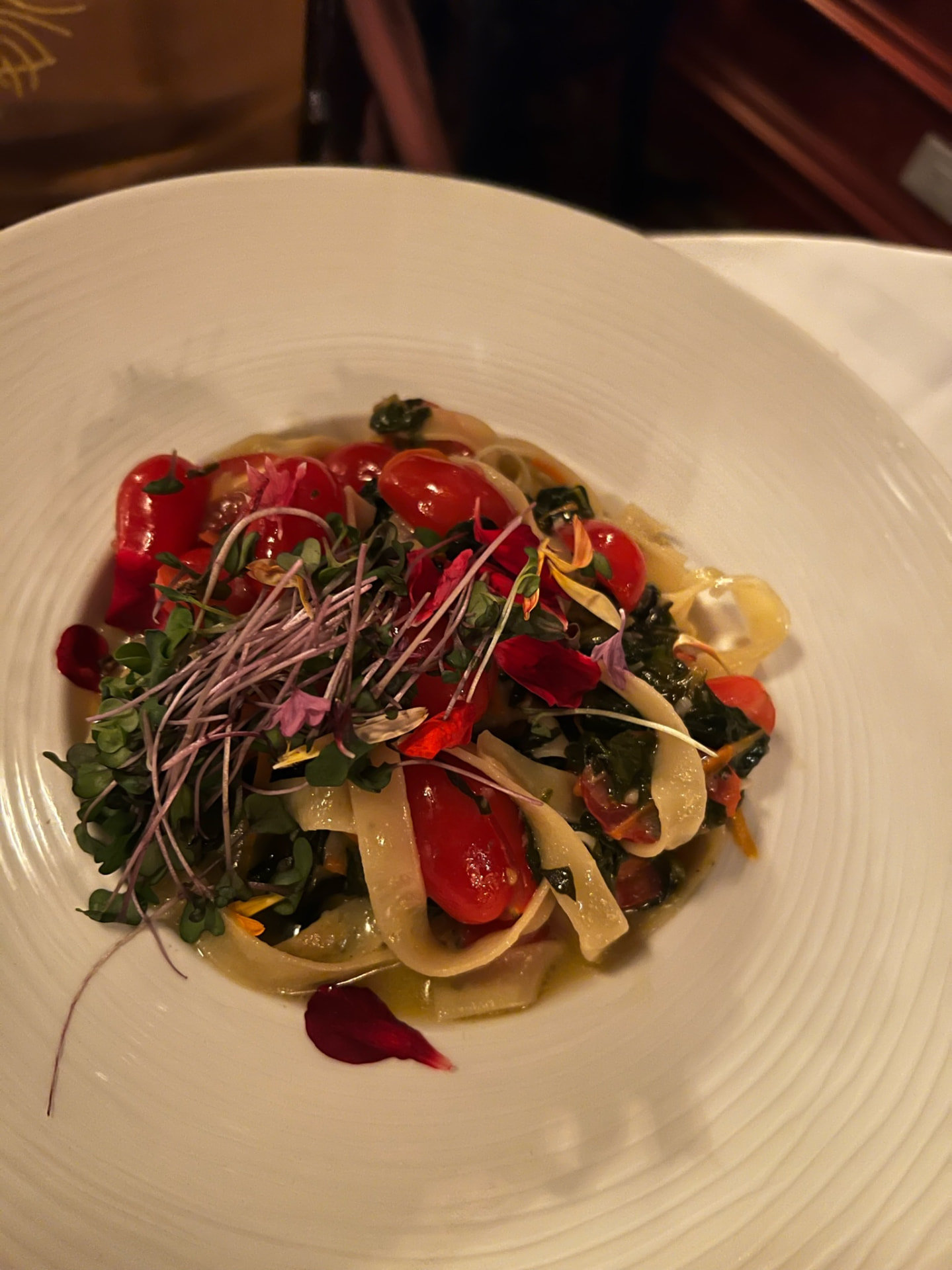 Pasta with tomatoes, greens, and edible flowers