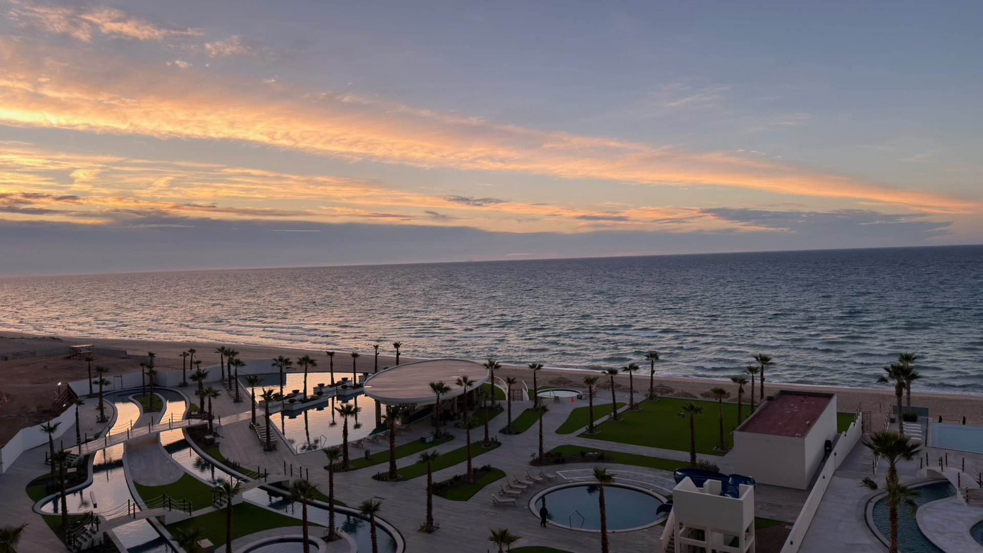 Oceanfront pools beneath a pastel December sunset