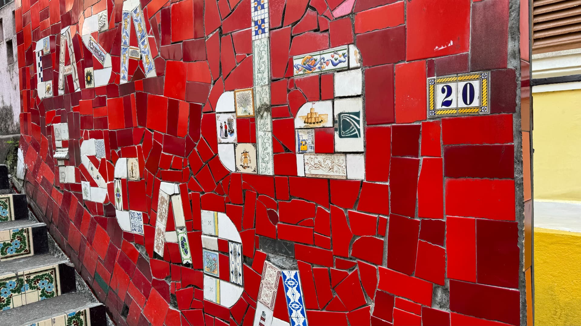 Red mosaic wall spelling Lapa beside the Selarón Steps