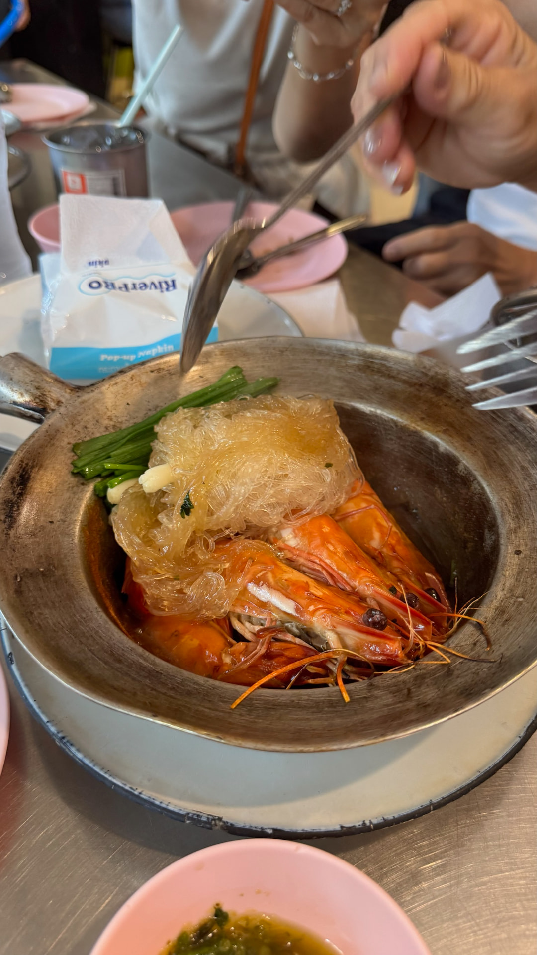 Clay-pot prawns covered with glass noodles and greens