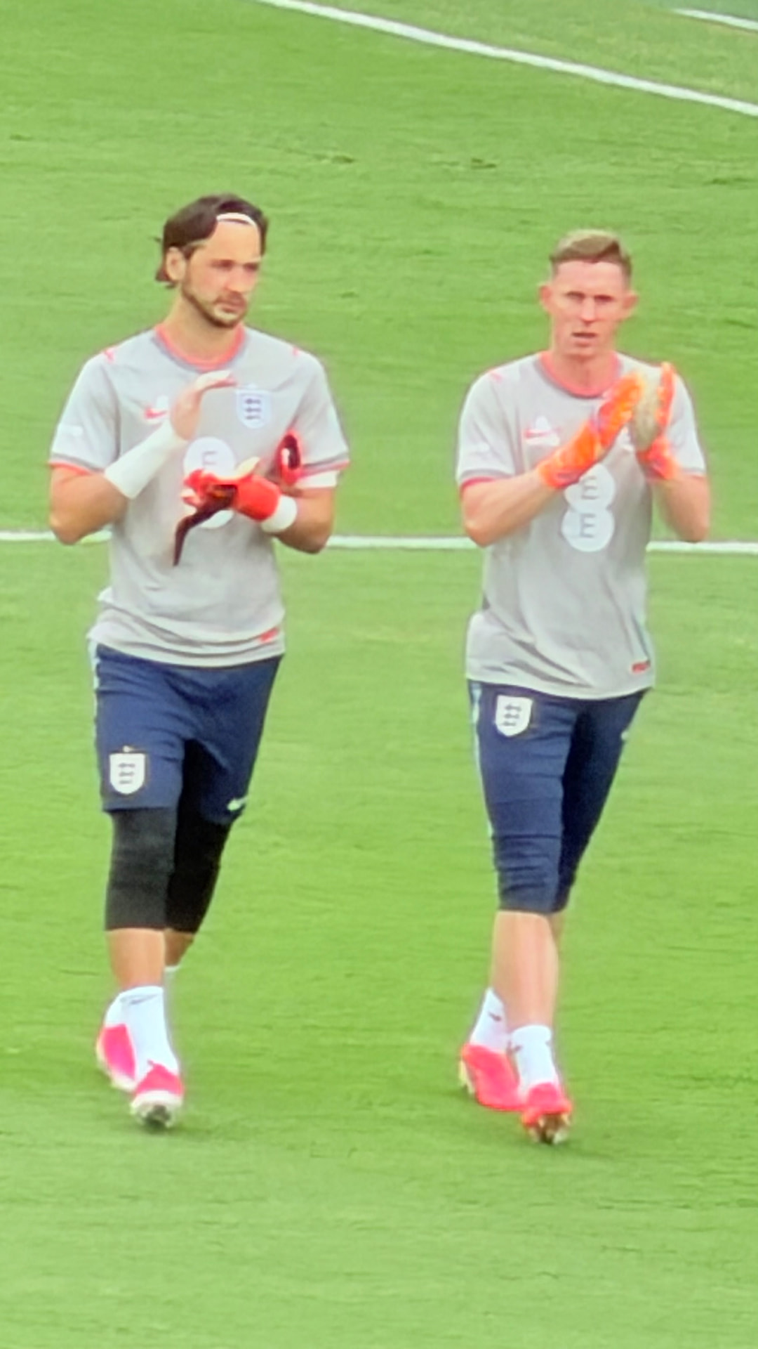 Two England goalkeepers applauding during warm-ups