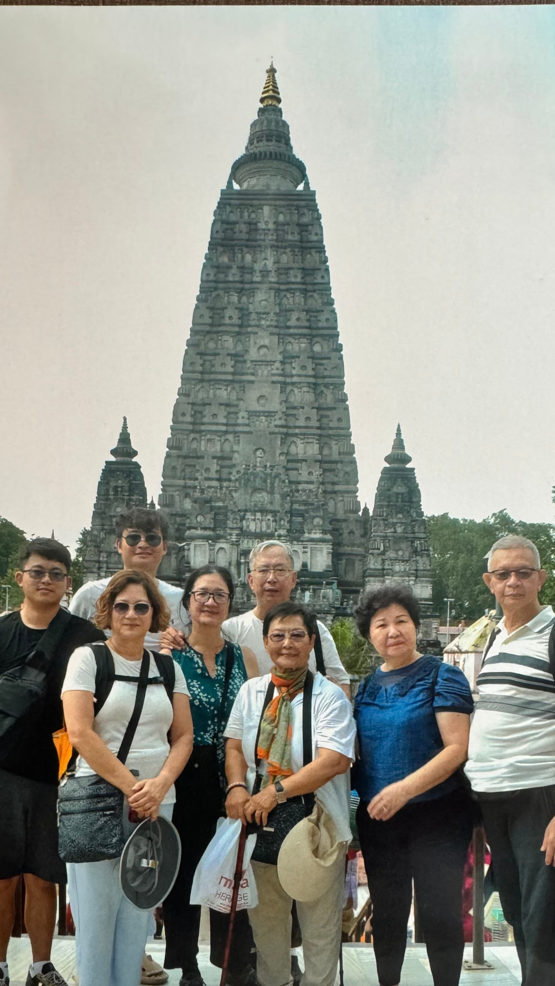 Our group poses beneath the soaring spire of the Mahabodhi Temple. — Bodh Gaya, Bihar, India.