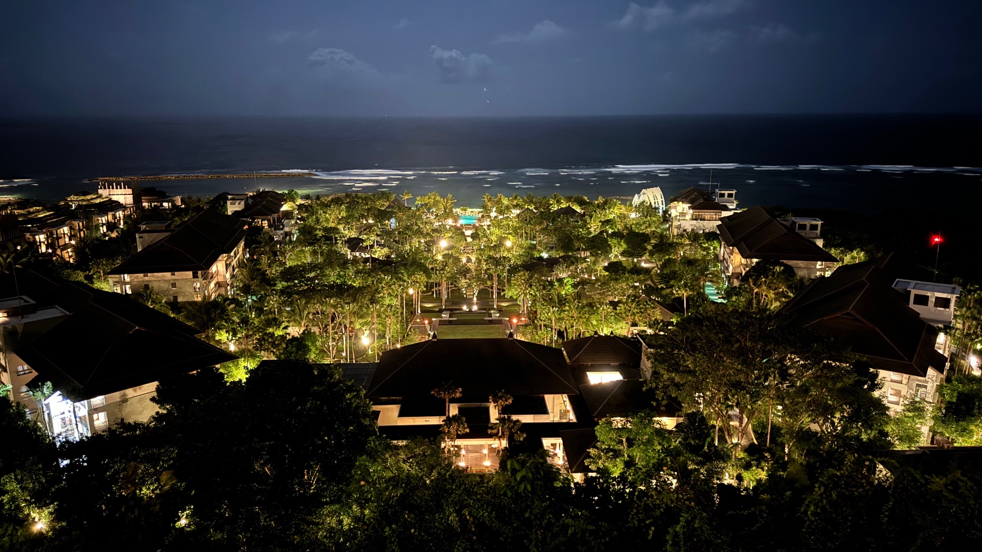 Panoramic nighttime view across the resort toward the ocean