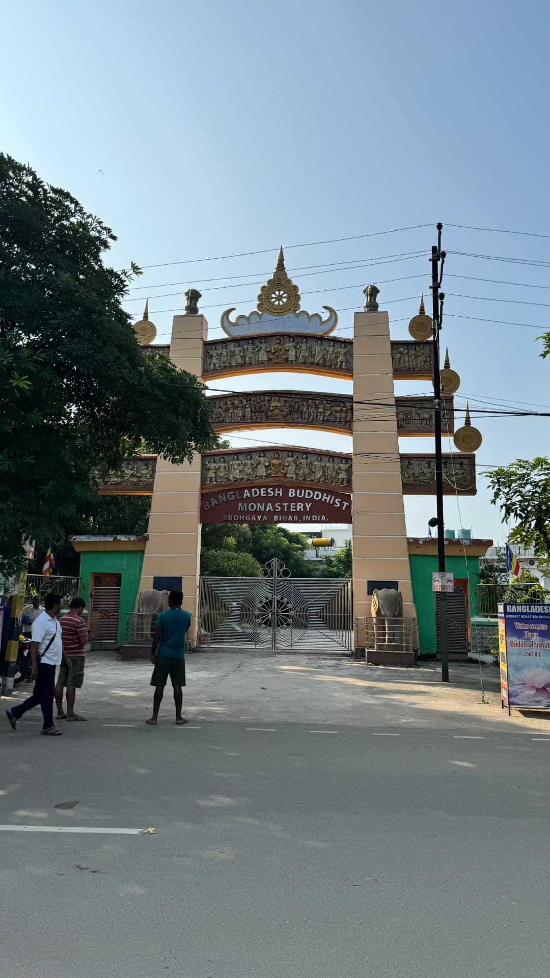 A monumental gateway marks another monastery visit. — Bodh Gaya, Bihar, India.