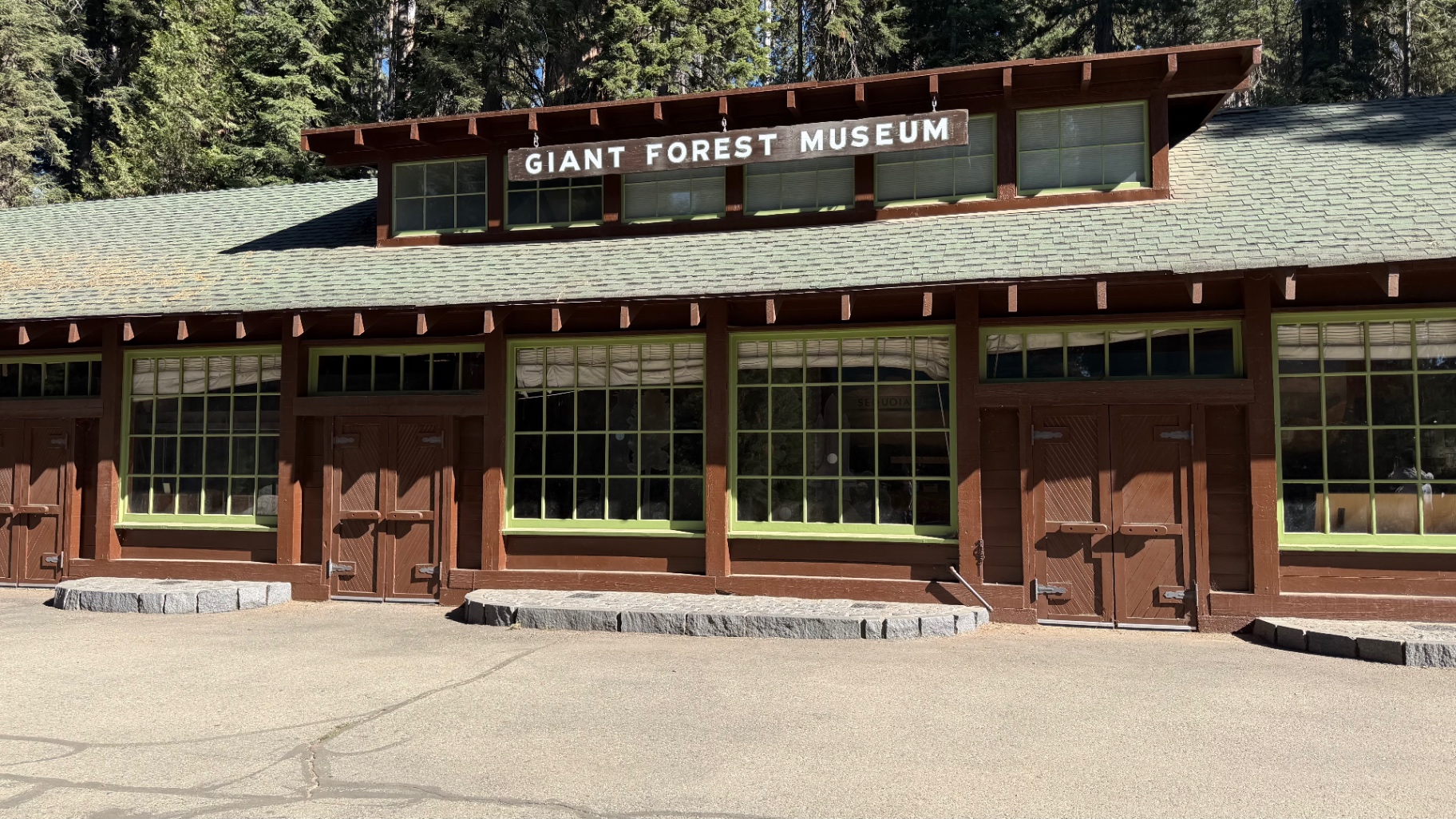 The Giant Forest Museum building with its green-trimmed windows and hanging sign