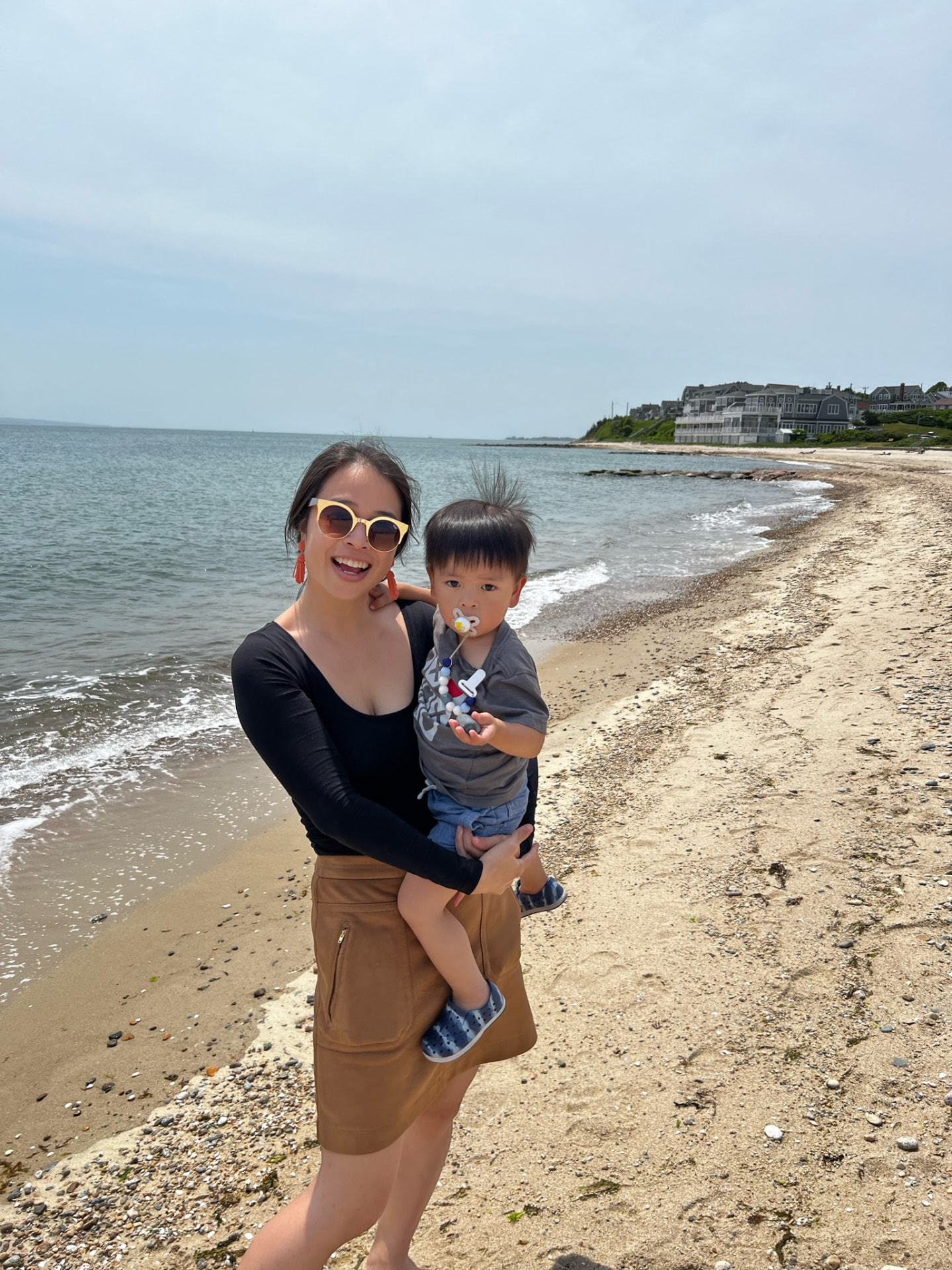 Mother holding her child on a quiet Cape Cod beach