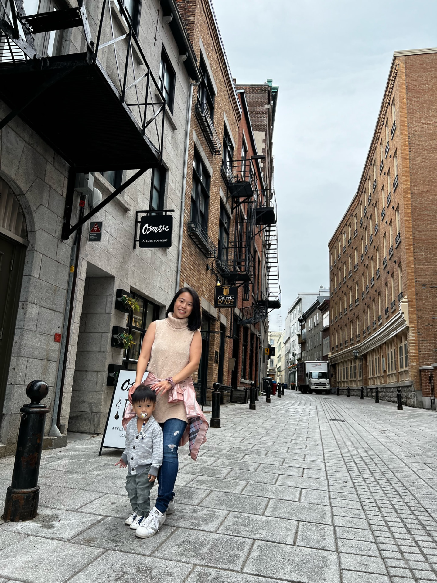 Mother and child on a quiet pedestrian street in Québec City