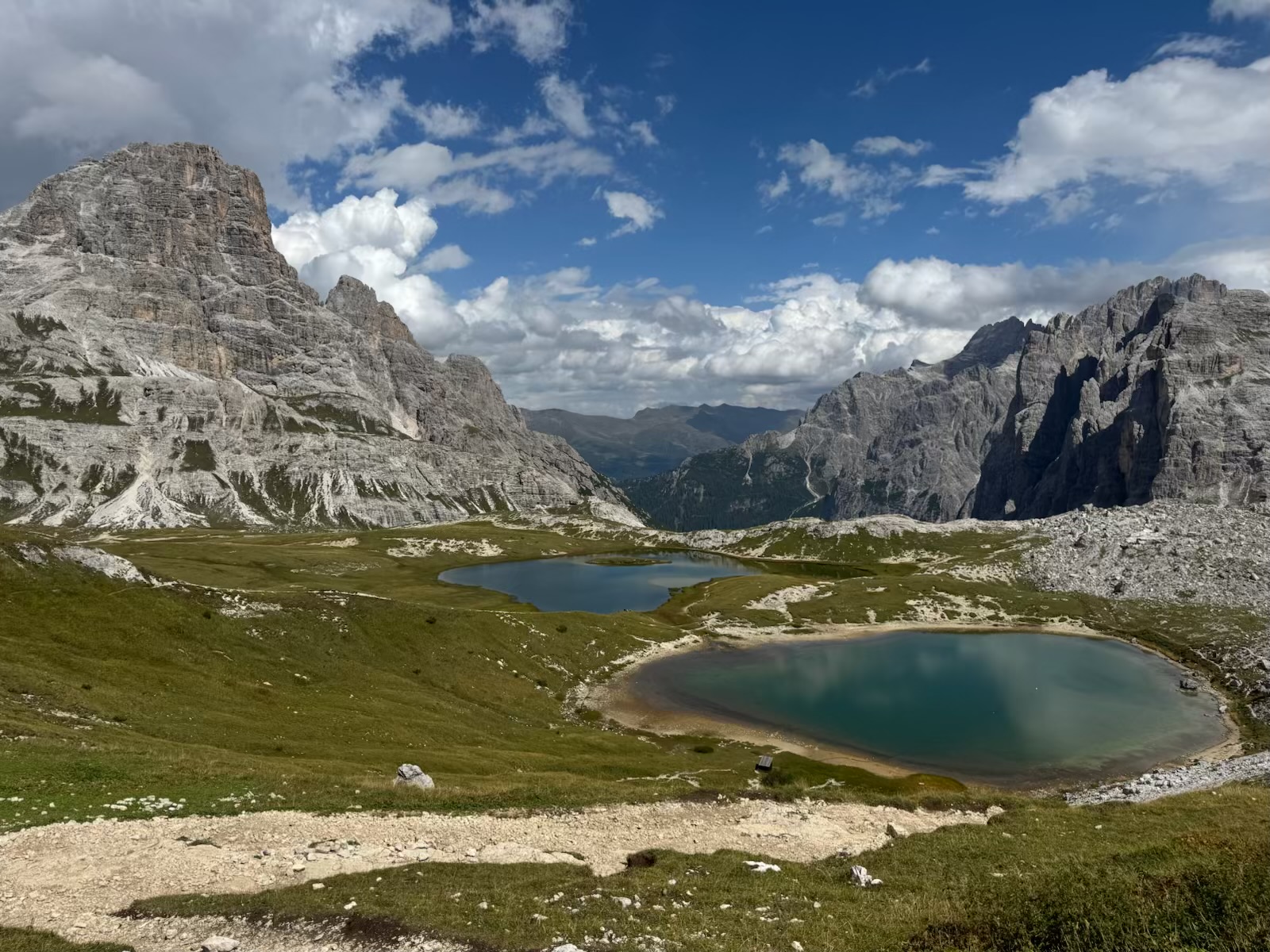 Two blue alpine lakes resting between pale limestone mountains