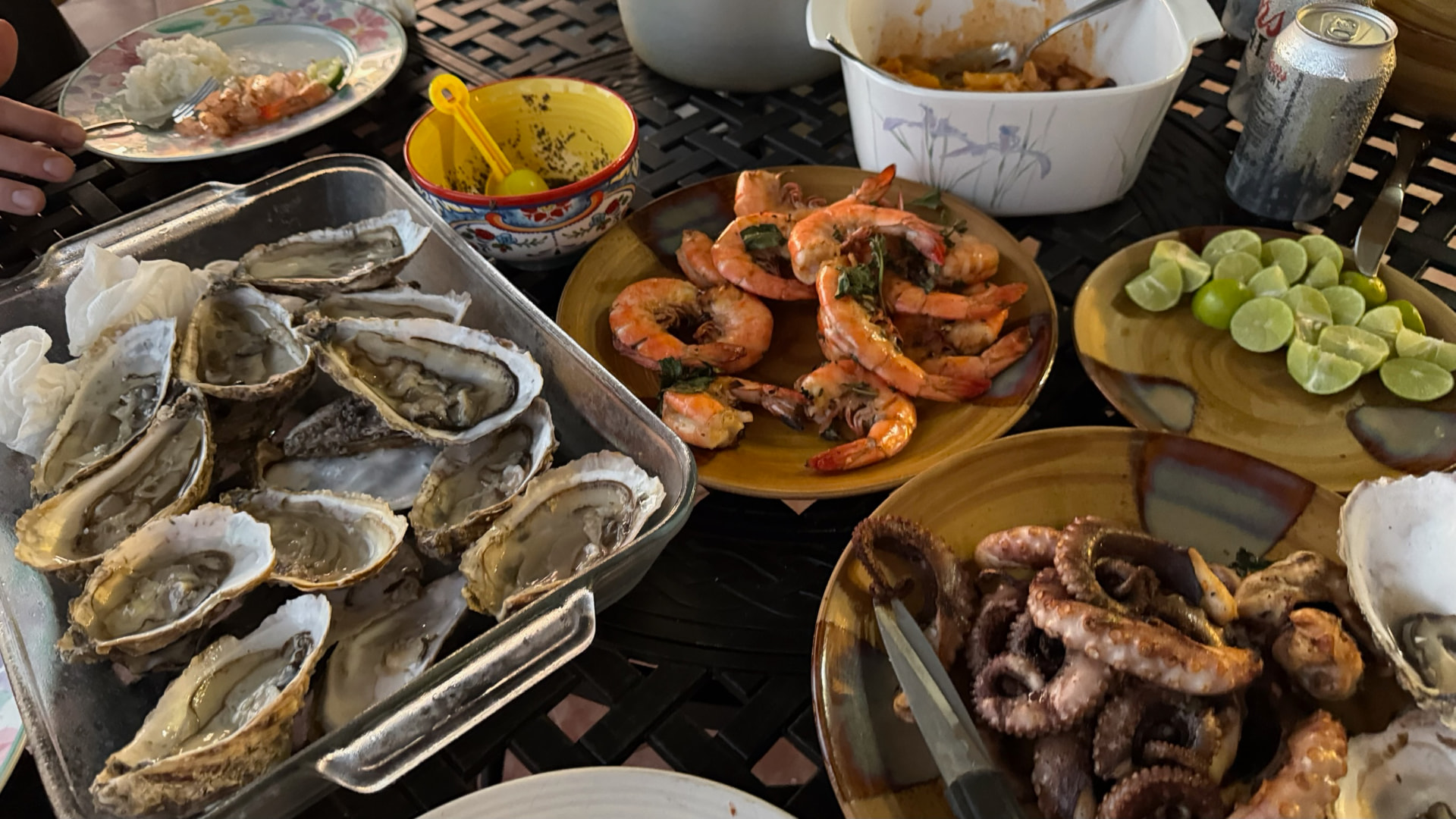 Table filled with oysters, shrimp, octopus, and fresh limes