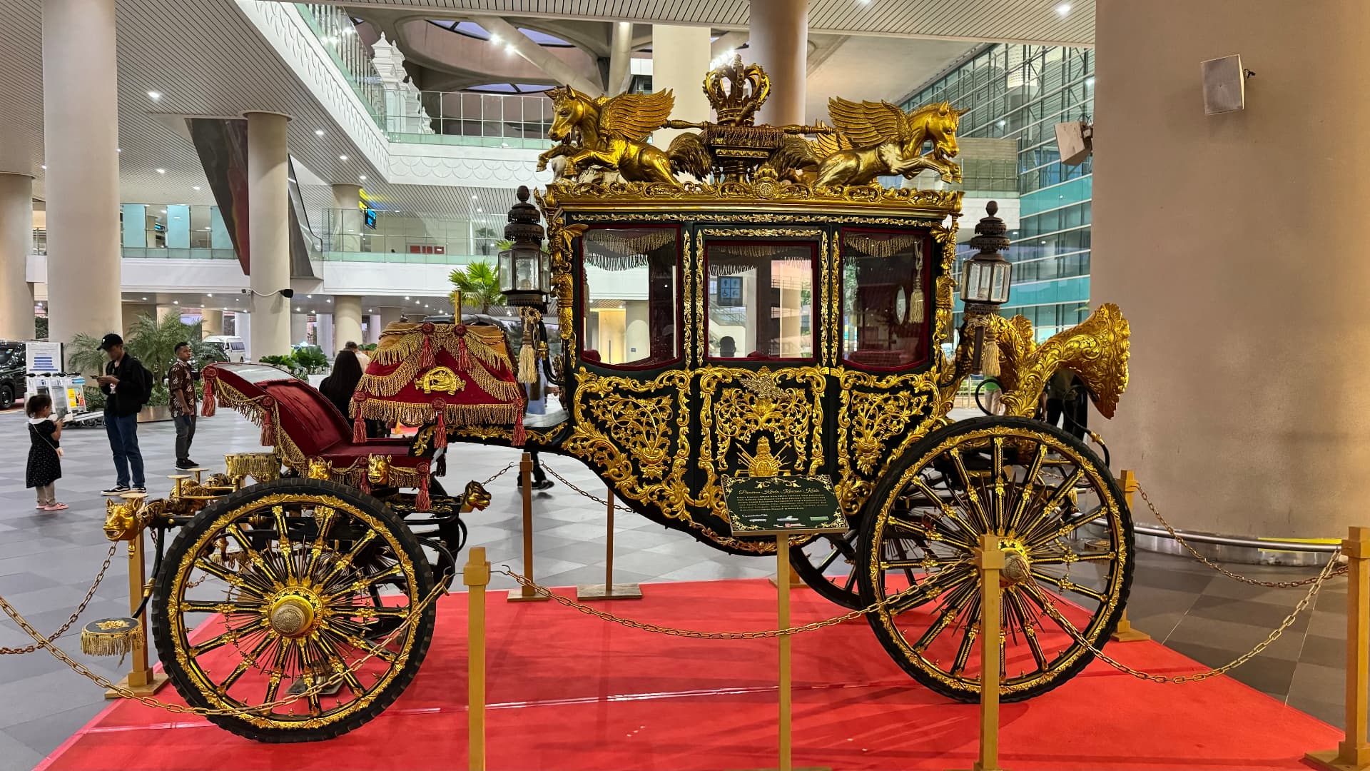 Decorative gilded carriage on display at Yogyakarta airport