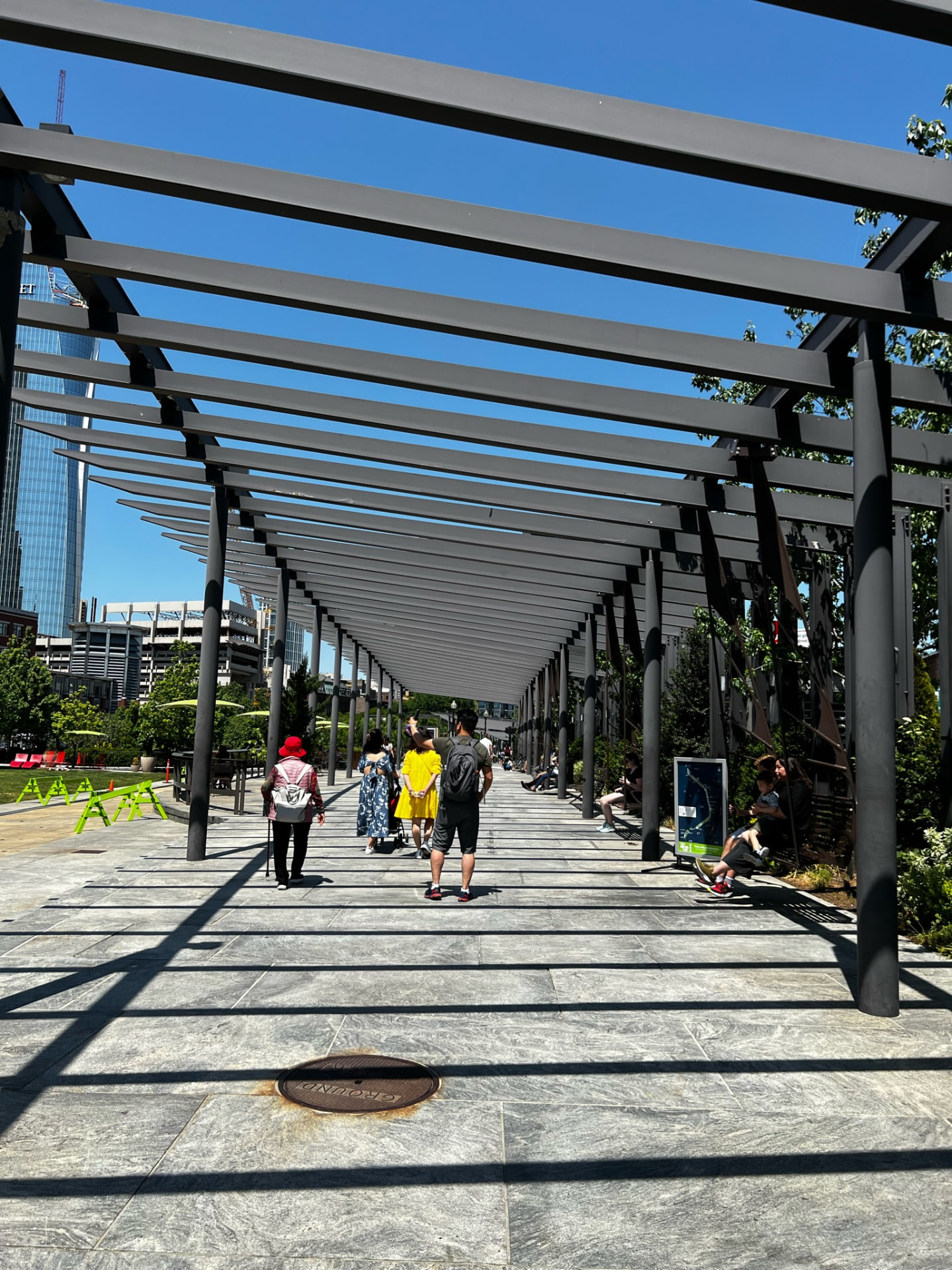 Shaded walkway through a sunny Boston park