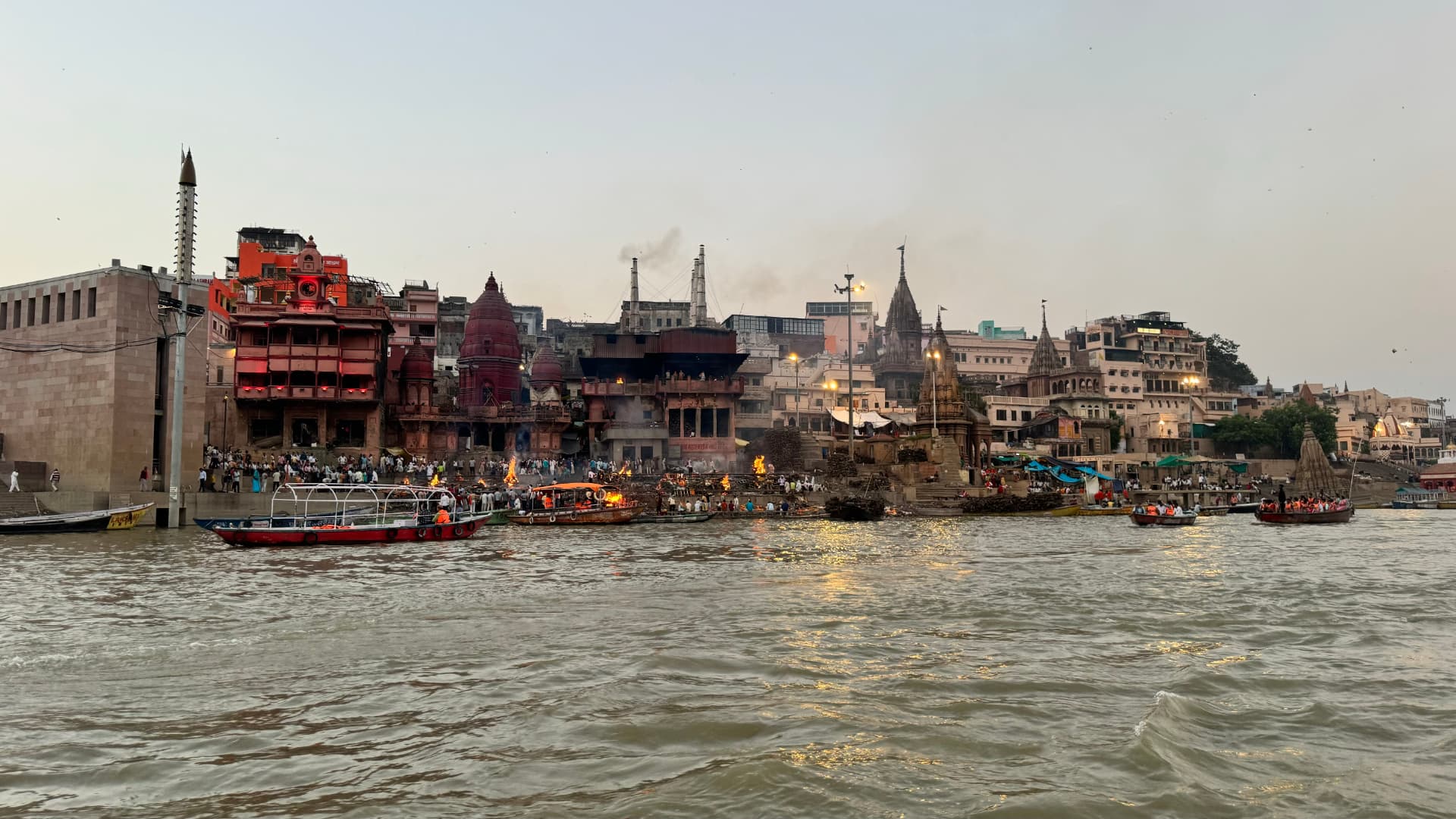Temples and buildings line the steps descending to the Ganges. — Varanasi, Uttar Pradesh, India.