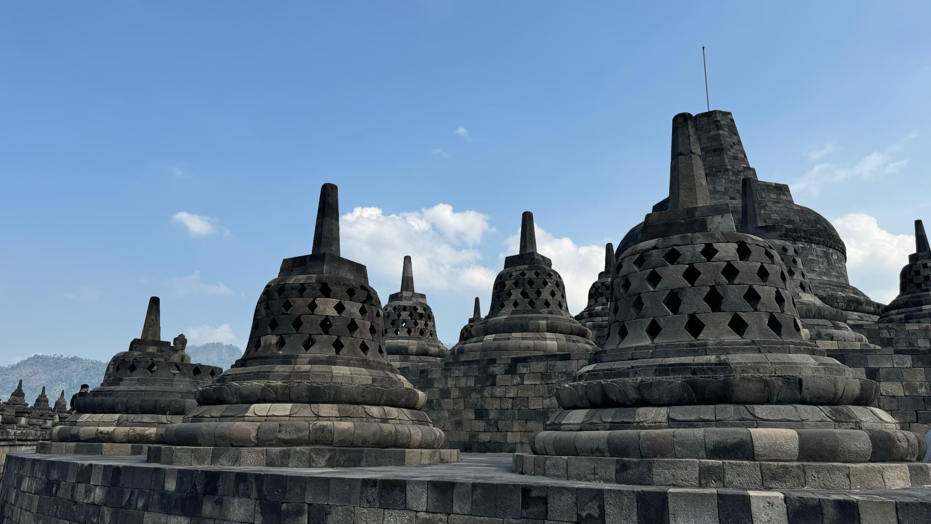 Perforated bell-shaped stupas on Borobudur's upper terraces