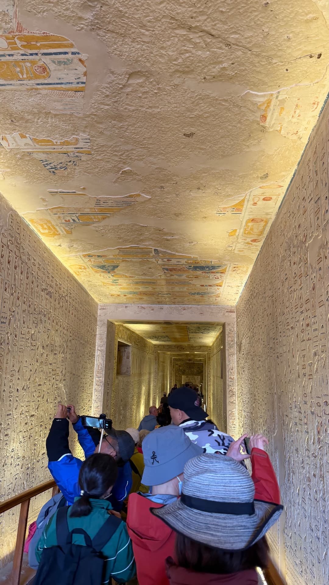 A descending tomb passage with a painted astronomical ceiling and inscribed walls