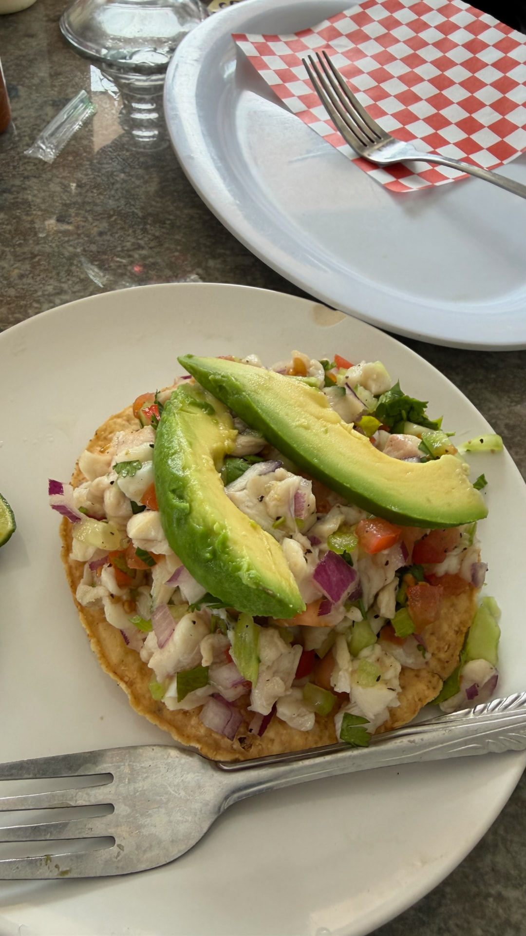 Fish ceviche tostada topped with avocado