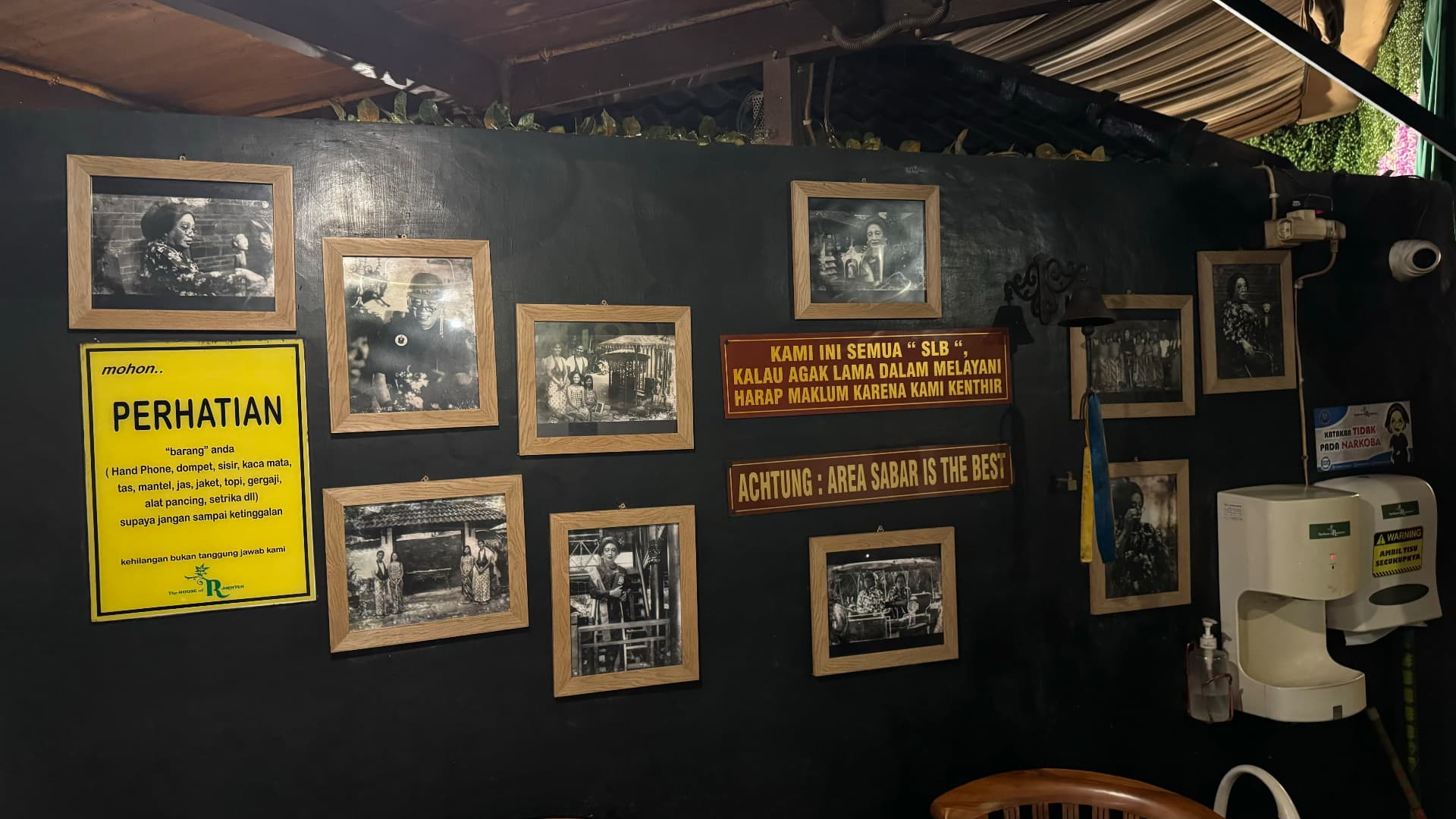 Framed photographs on the wall of the House of Raminten