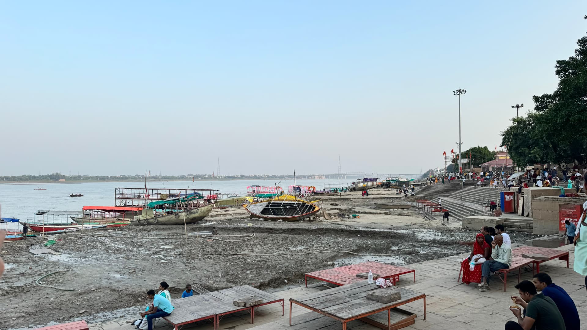 Boats rest beside the broad steps along the Ganges riverbank. — Varanasi, Uttar Pradesh, India.