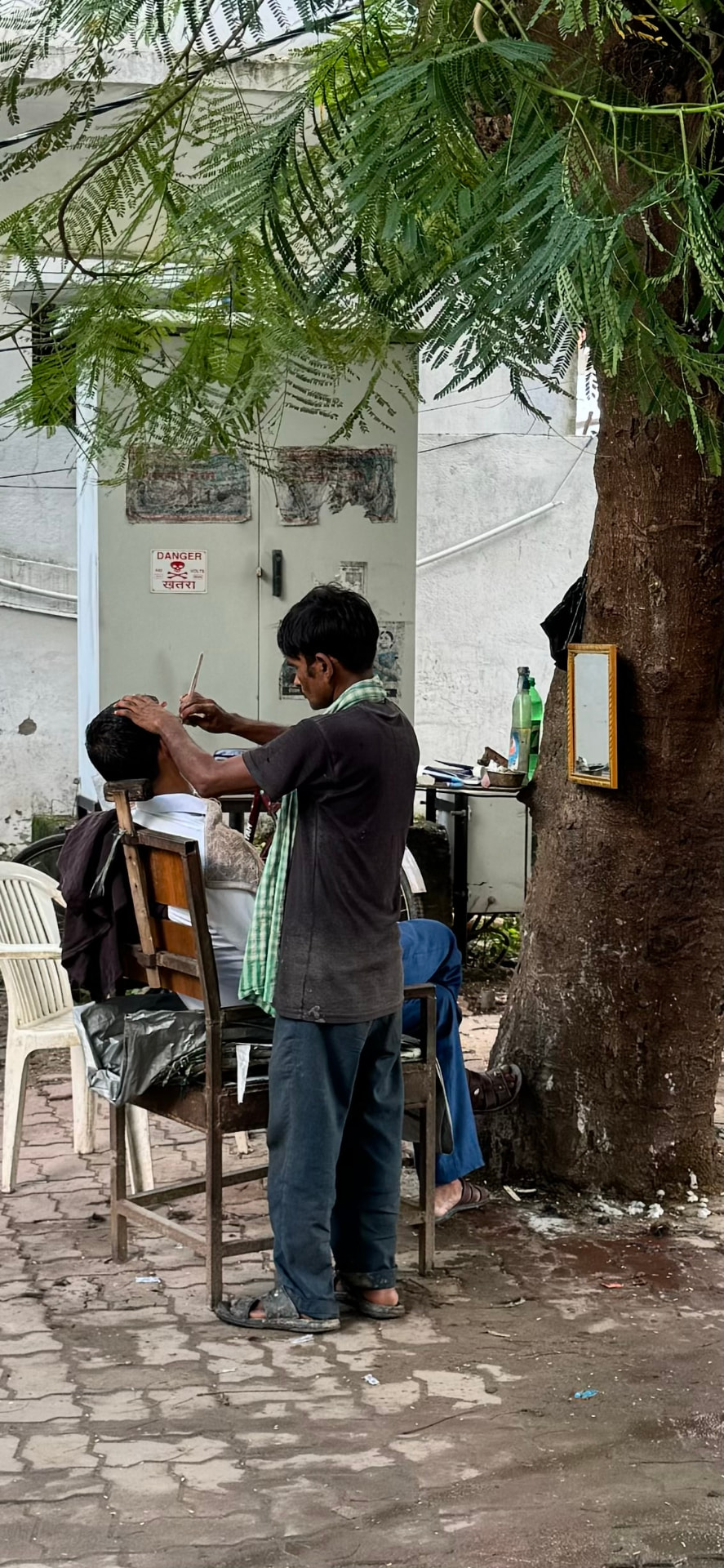 A pause beneath the trees beside a small roadside stall. — Bodh Gaya, Bihar, India.